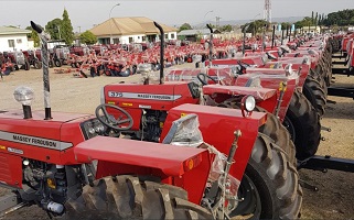 Commissioner inspecting tractors